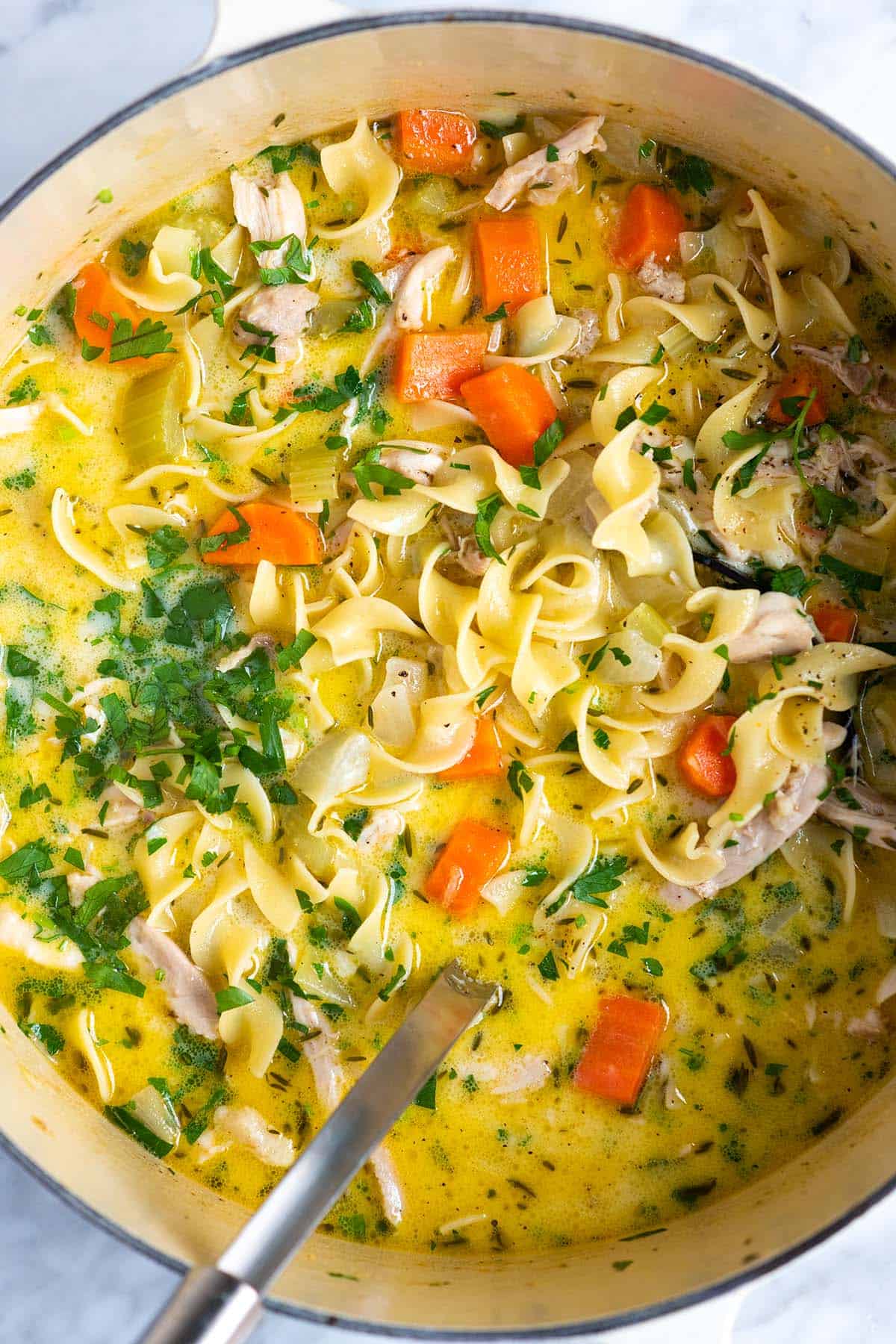 A pot of creamy chicken noodle soup perfect for fall