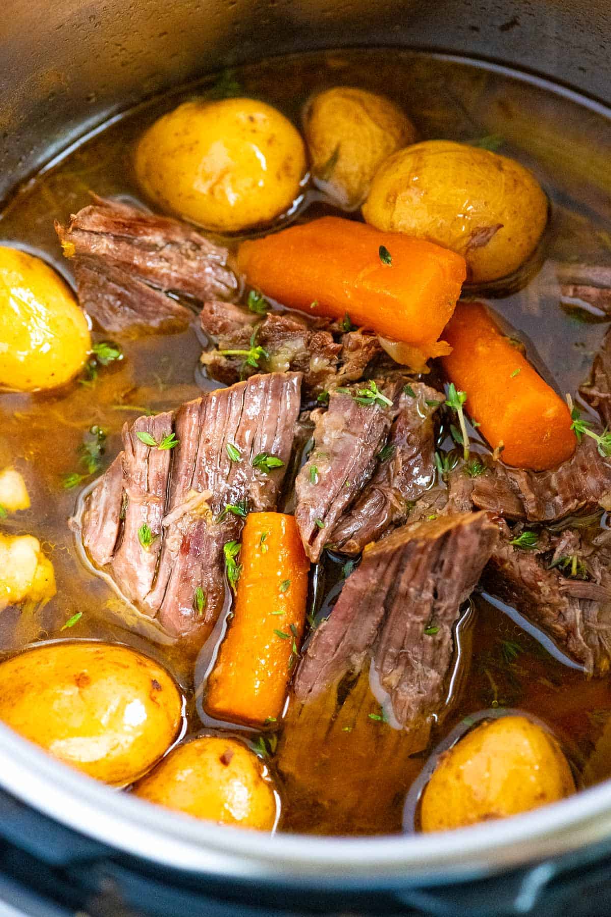 Fork-tender Instant Pot pot roast with chuck roast, carrots and potatoes.
