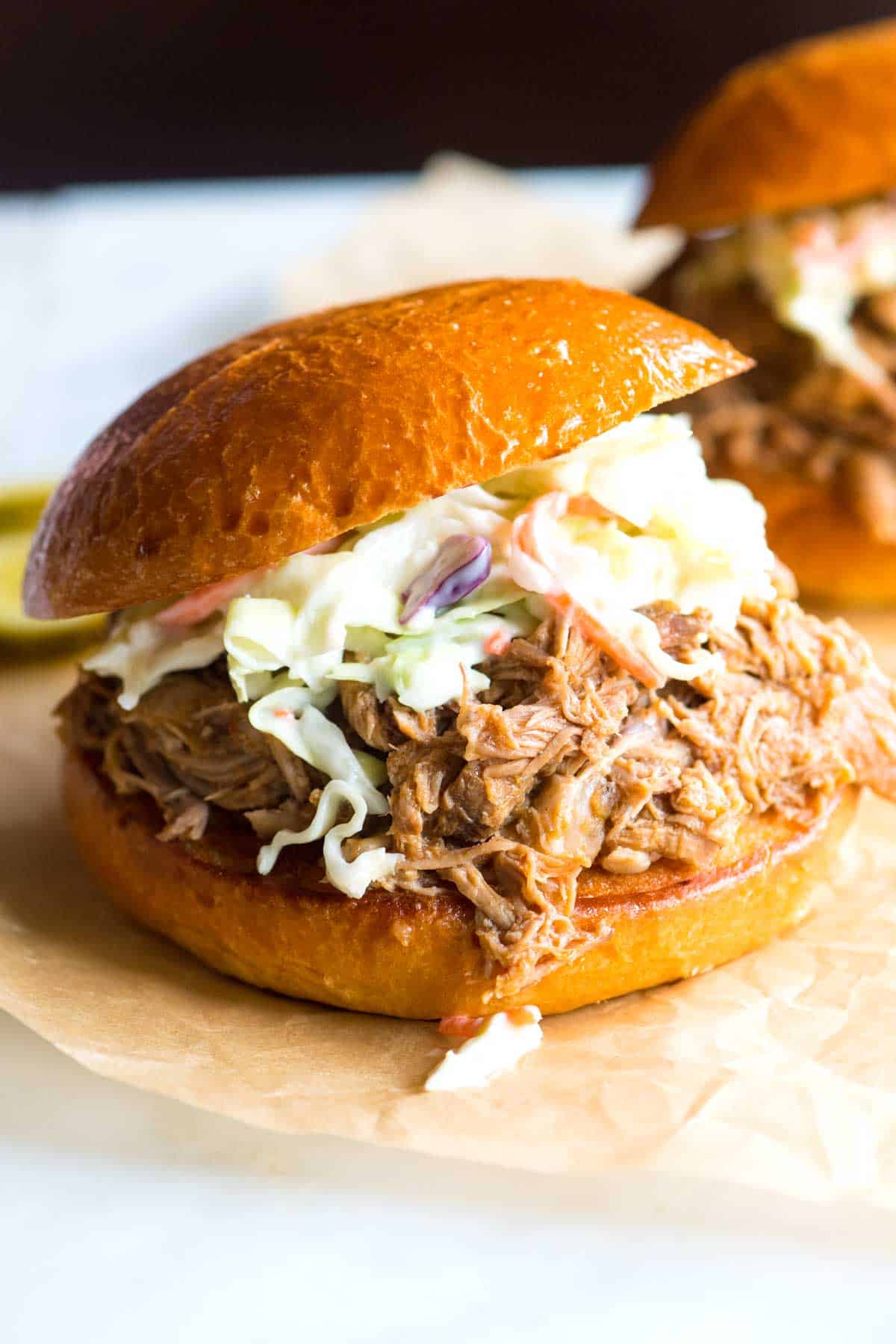 Slow Cooker Pulled Pork piled onto sandwiches